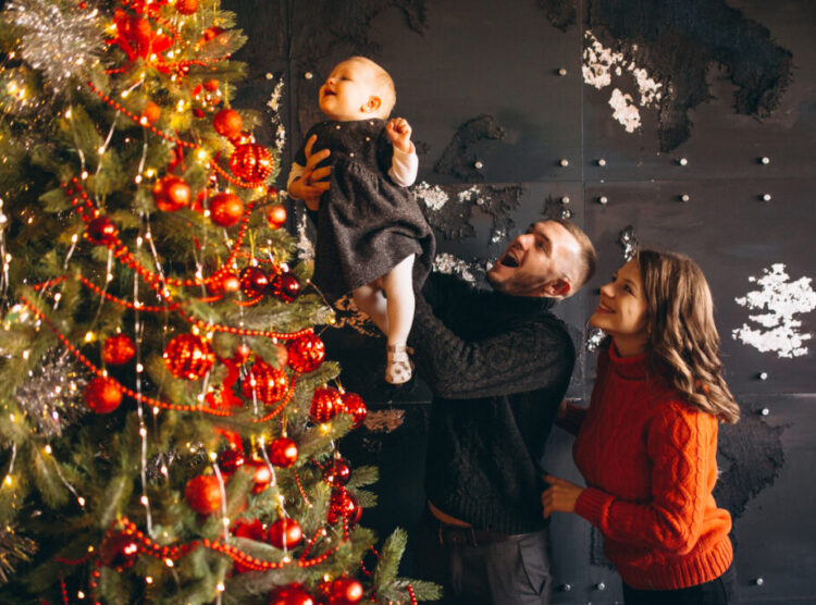 Family on Christmas decorating Christmas tree